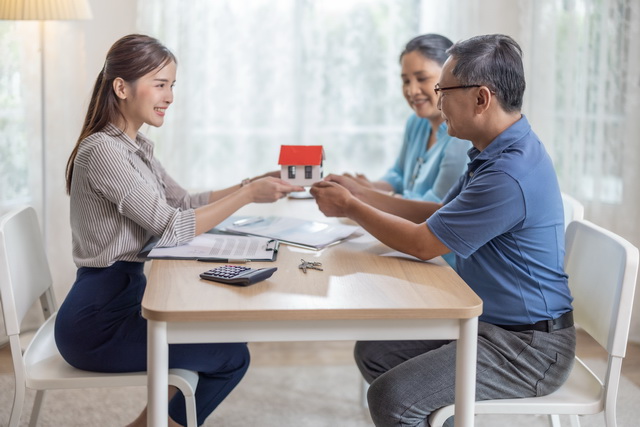 Homeowners discussing private mortgage options with a financial advisor, highlighting flexible financing solutions for diverse financial situations.